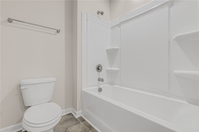 bathroom featuring shower / tub combination and toilet