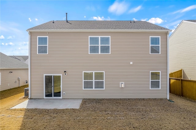 rear view of house featuring a patio and a yard