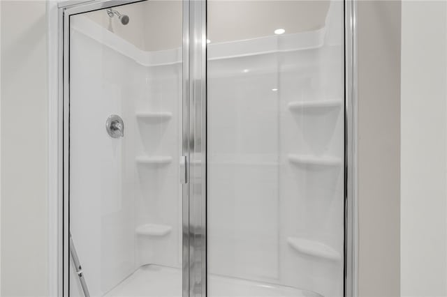 bathroom with a shower with door