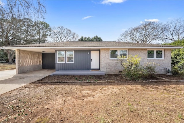 ranch-style house featuring a carport