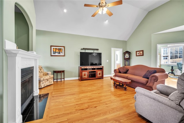 living room featuring high vaulted ceiling, ceiling fan, and wood-type flooring