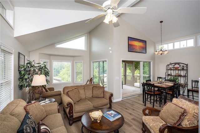 living room featuring high vaulted ceiling, ceiling fan, and light hardwood / wood-style flooring