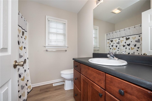 bathroom featuring toilet, hardwood / wood-style flooring, and vanity