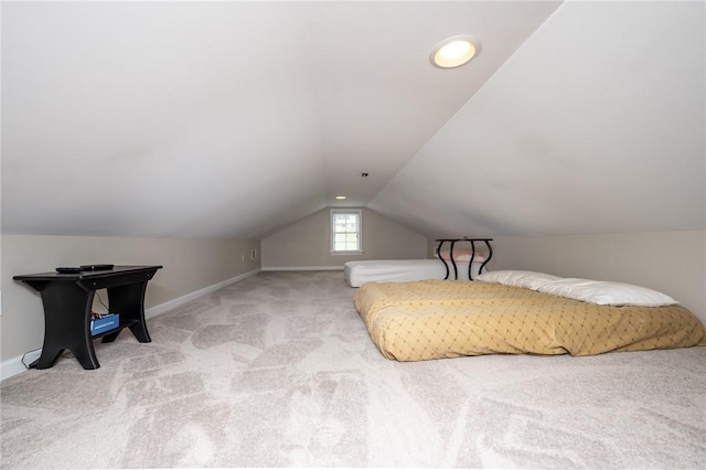 bedroom featuring light carpet and lofted ceiling