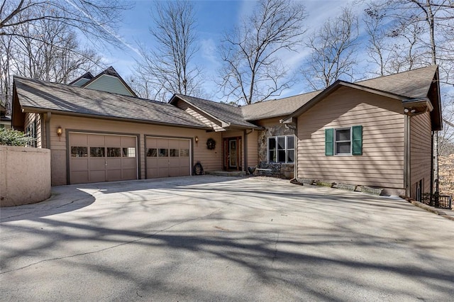 ranch-style house featuring driveway and an attached garage