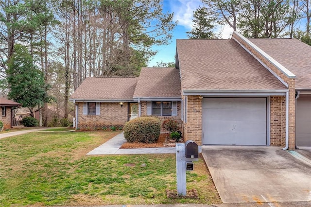 view of front of property featuring a garage, concrete driveway, a front lawn, and brick siding