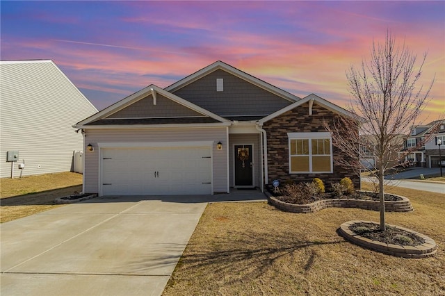 view of front of home with a garage, driveway, a yard, and stone siding