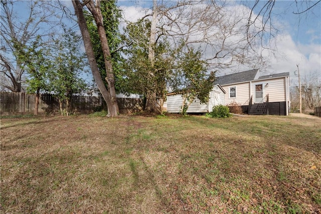 view of yard with entry steps and fence