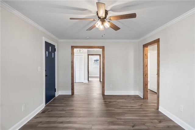 empty room with dark wood-type flooring, ornamental molding, baseboards, and a ceiling fan