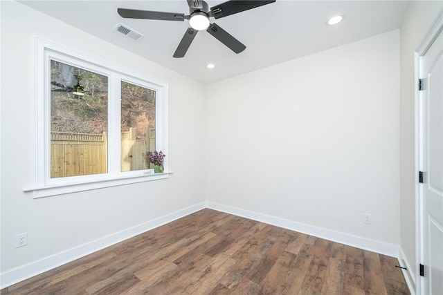 empty room featuring recessed lighting, wood finished floors, visible vents, and baseboards