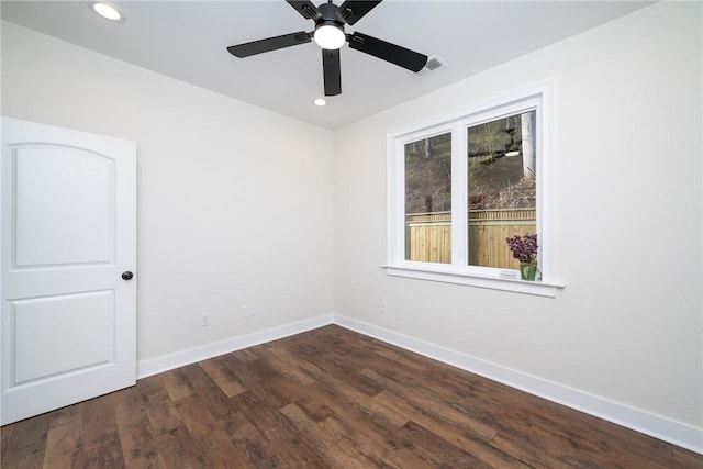 empty room with baseboards, visible vents, ceiling fan, dark wood-type flooring, and recessed lighting