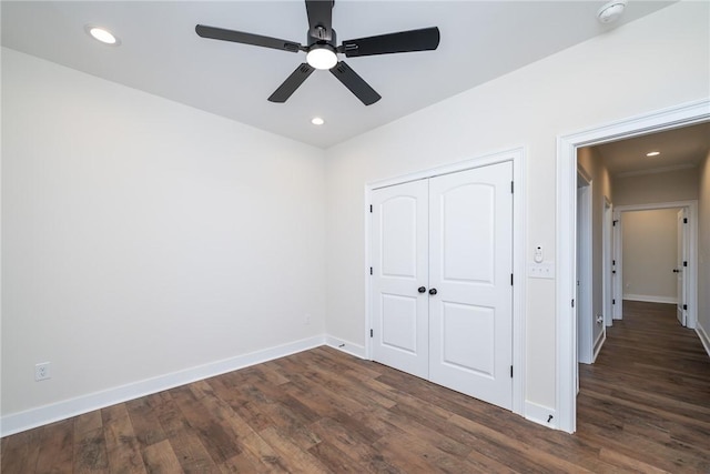 unfurnished bedroom with recessed lighting, dark wood finished floors, and baseboards