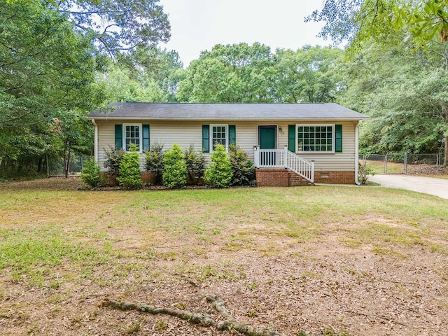 ranch-style home with a front lawn, crawl space, and fence