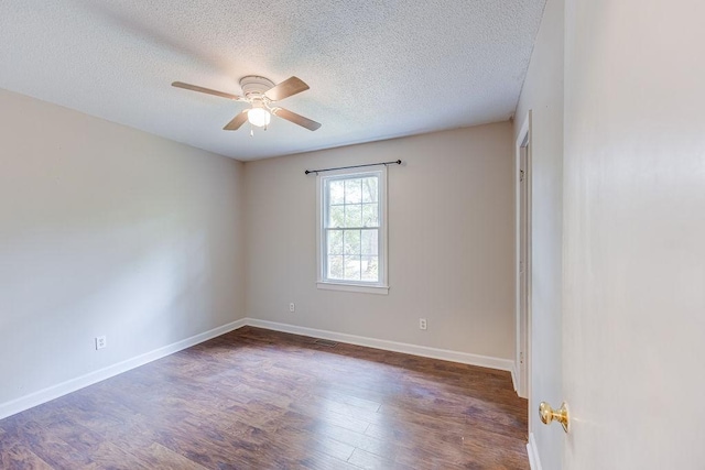 unfurnished room featuring visible vents, baseboards, ceiling fan, dark wood-style flooring, and a textured ceiling