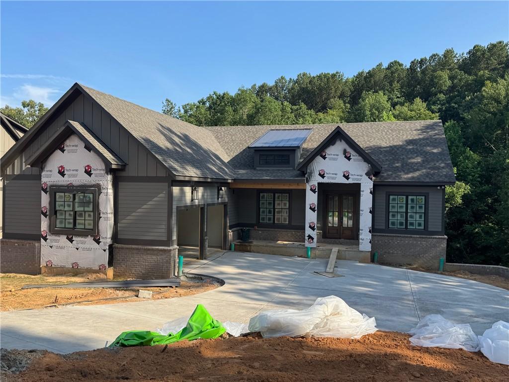 713 Hemlock Ct, Salem, SC 29676 - property under construction featuring brick siding, board and batten siding, french doors, and roof with shingles