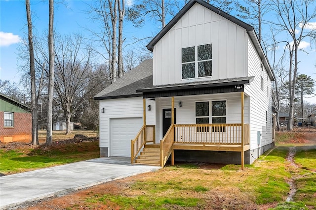 view of front of house with board and batten siding, a shingled roof, a front lawn, covered porch, and an attached garage