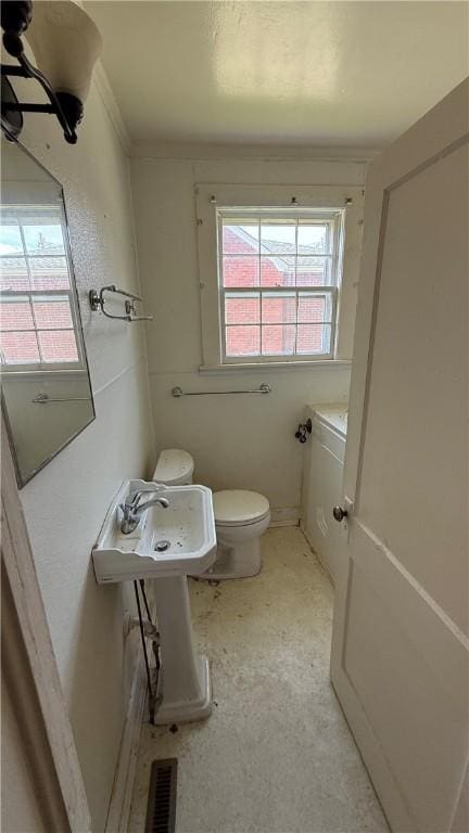 bathroom with visible vents, toilet, and baseboards