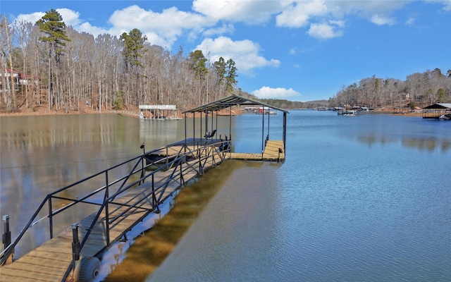 view of dock featuring a water view and a wooded view