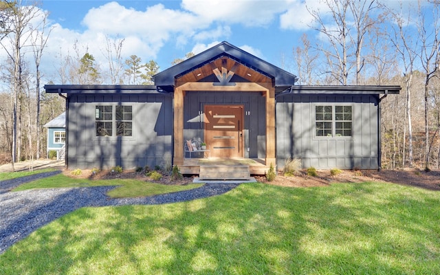 view of front facade featuring board and batten siding and a front yard