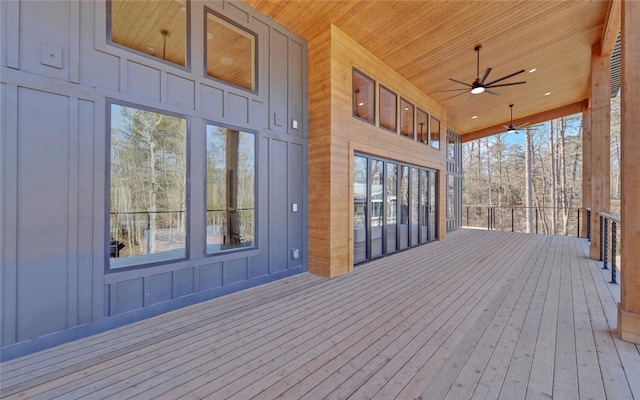 wooden terrace featuring a ceiling fan