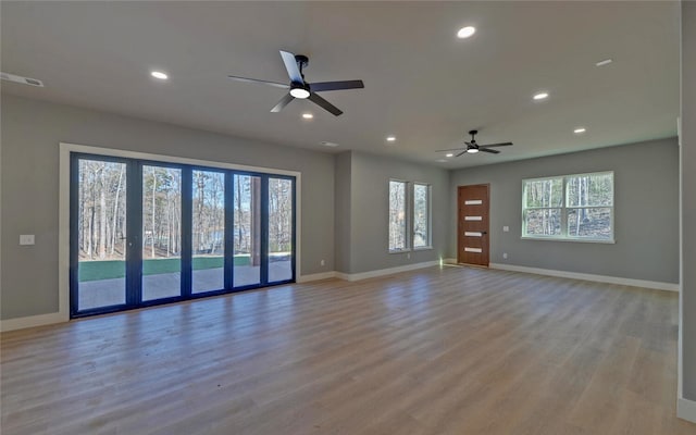 unfurnished room featuring light wood-style floors, recessed lighting, and baseboards