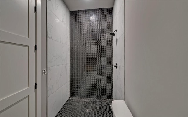 full bathroom featuring toilet and a stall shower