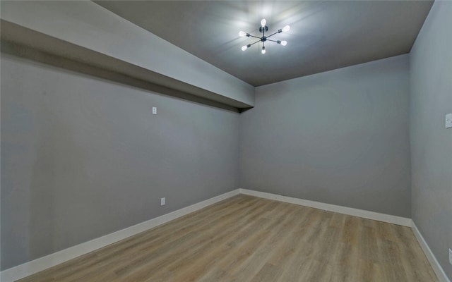 empty room with baseboards and light wood finished floors