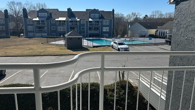 exterior space with a pool and a residential view