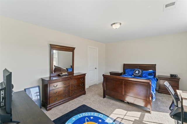 bedroom featuring visible vents and light colored carpet