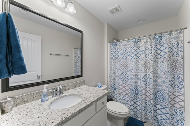 full bath with visible vents, vanity, and toilet