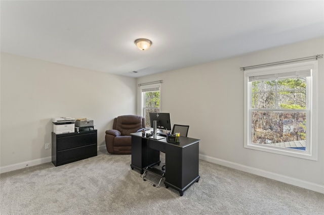 office area with light carpet and baseboards