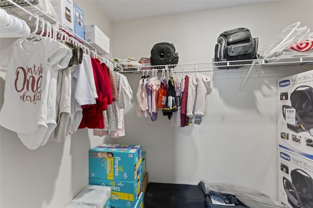 walk in closet featuring stacked washing maching and dryer