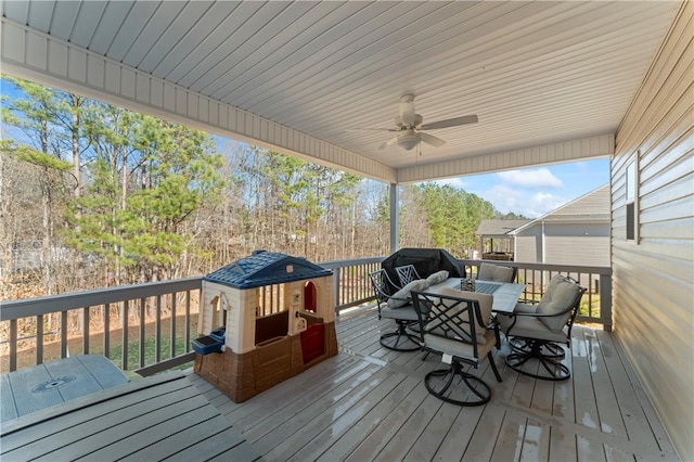 wooden terrace featuring ceiling fan and outdoor dining area