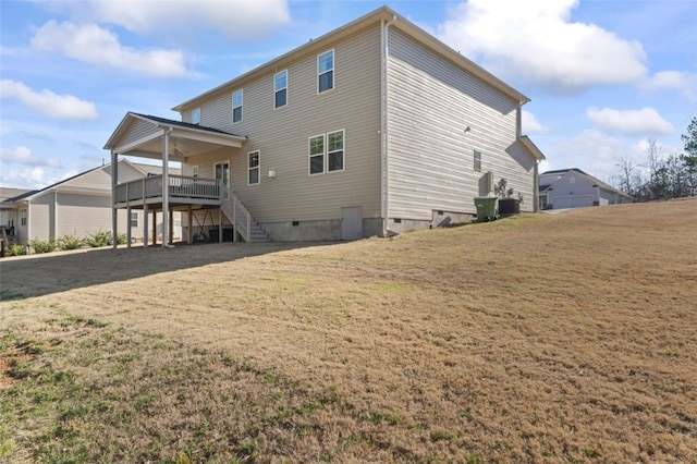 rear view of house with central AC unit, a lawn, crawl space, stairs, and a wooden deck