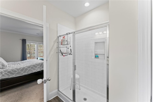 bathroom featuring baseboards, ensuite bath, crown molding, a shower stall, and recessed lighting