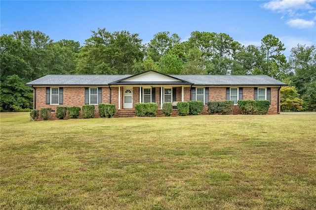 ranch-style house featuring a porch, a front yard, and brick siding