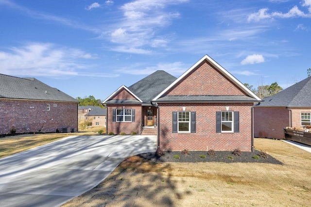 view of front facade featuring brick siding and a front yard