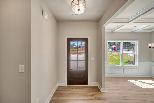 entryway with light wood finished floors, plenty of natural light, and visible vents