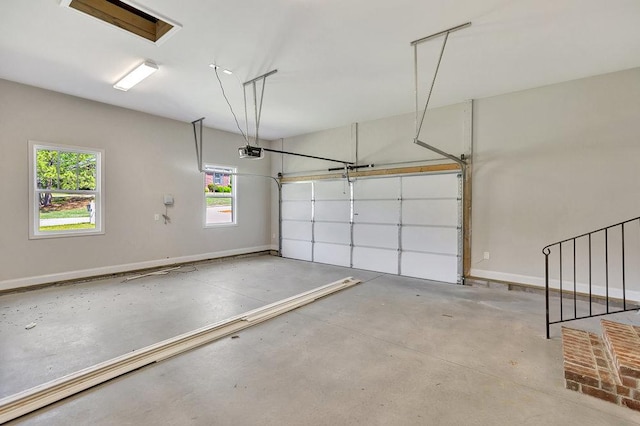 garage featuring a garage door opener and baseboards