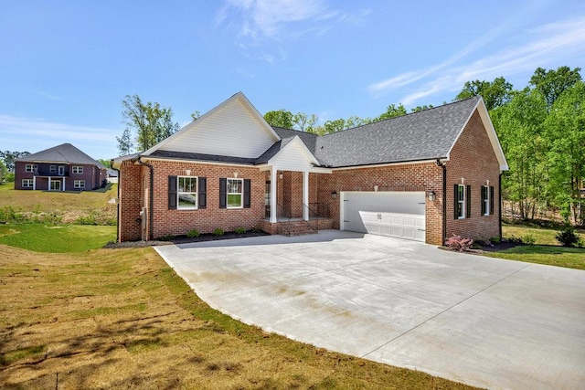 view of front of property with a garage, driveway, brick siding, and a front lawn