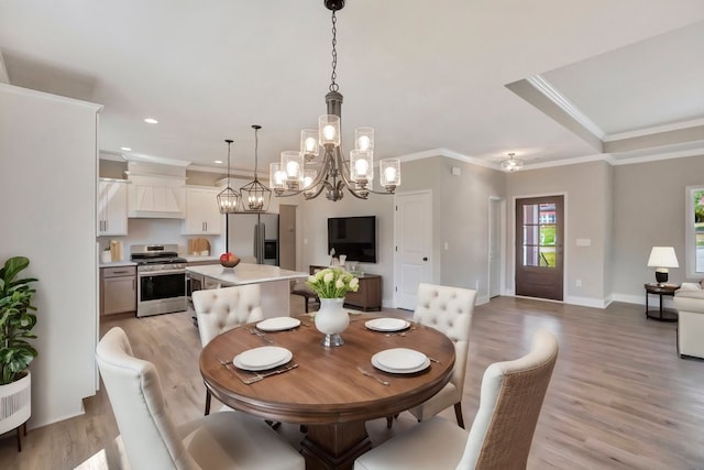 dining space with recessed lighting, crown molding, light wood-style flooring, and baseboards