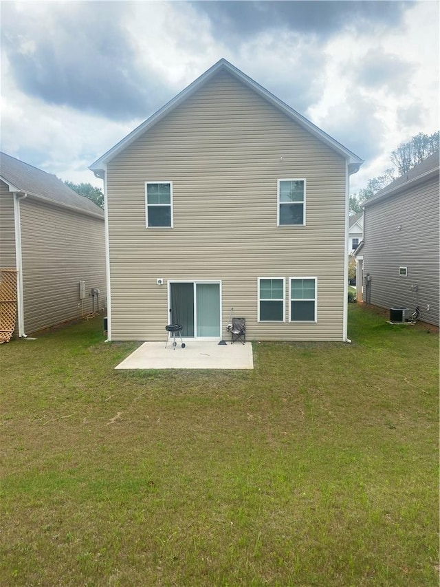 rear view of property with a yard, a patio, and central air condition unit