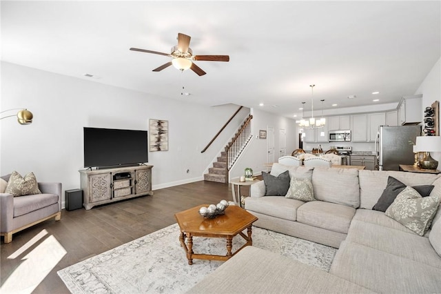 129 Rushing Creek Ln, Piedmont, SC 29673 - living room featuring dark wood finished floors, recessed lighting, stairway, baseboards, and ceiling fan with notable chandelier