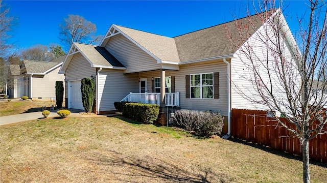 view of front facade with concrete driveway, an attached garage, fence, and a front yard