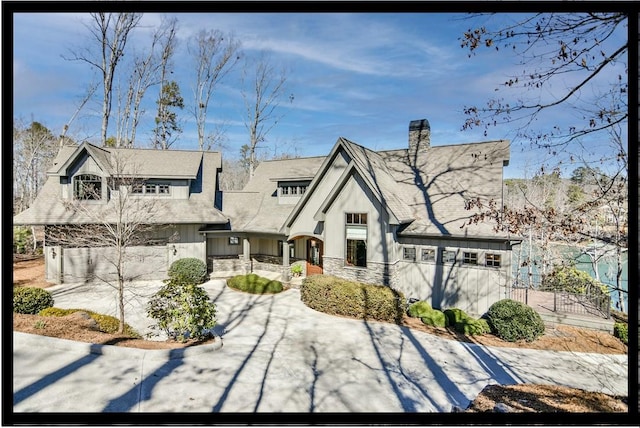 view of front facade with stone siding and a chimney