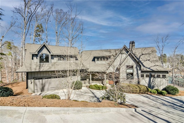 view of front of property with a chimney and board and batten siding