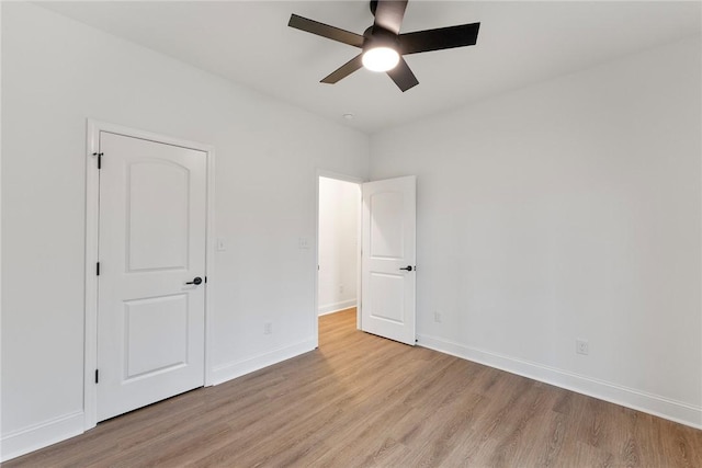 unfurnished bedroom with light wood-type flooring, baseboards, and a ceiling fan