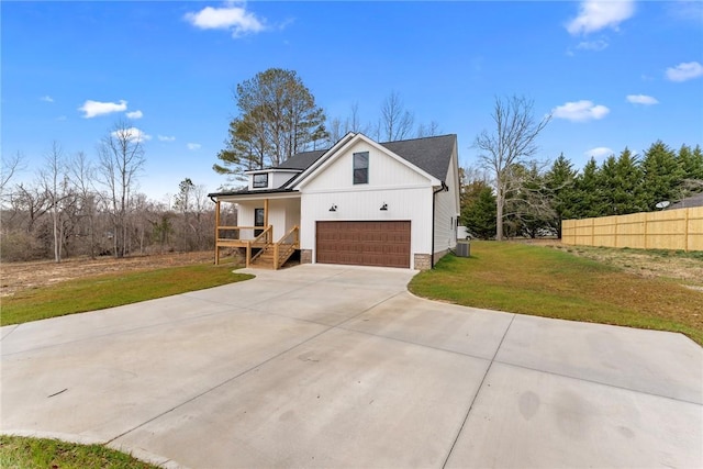 view of front of home featuring a porch, a front yard, driveway, and fence