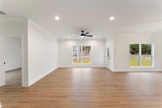 unfurnished living room with baseboards, recessed lighting, a wealth of natural light, and light wood-style floors