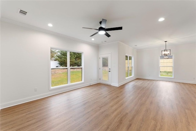 unfurnished living room featuring light wood-type flooring, visible vents, crown molding, and baseboards